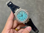 Patek Philippe watch with teal dial, diamond bezel, and dark blue leather strap