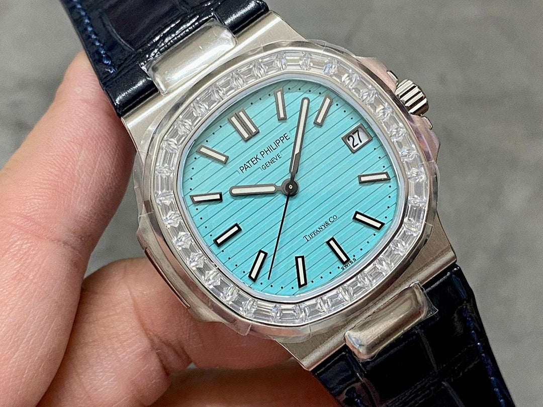 Patek Philippe watch close-up with teal dial, diamond bezel, and date window