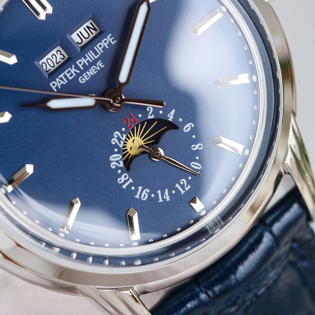 Patek Philippe watch dial close-up with blue face, raised markers, and moonphase