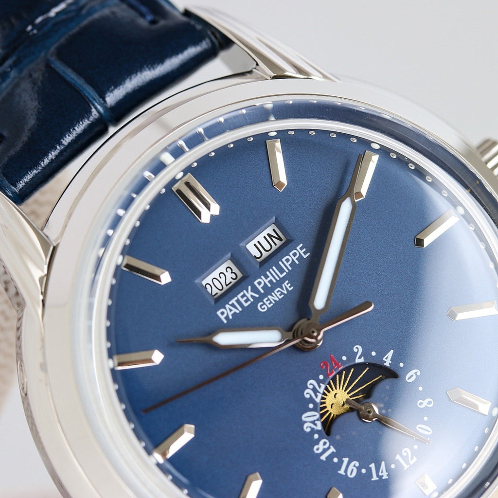 Patek Philippe watch dial close-up with blue face, minute track, and moonphase