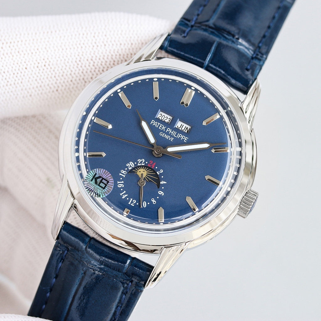 Patek Philippe watch with blue dial, silver bezel, and navy leather strap, moonphase