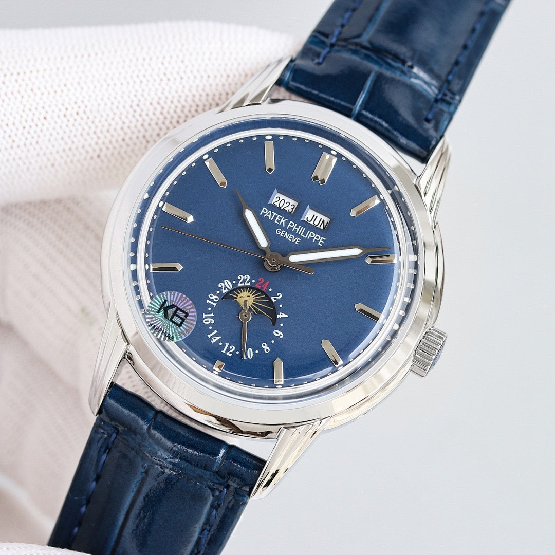 Patek Philippe watch with blue dial, silver bezel, and navy leather strap, moonphase