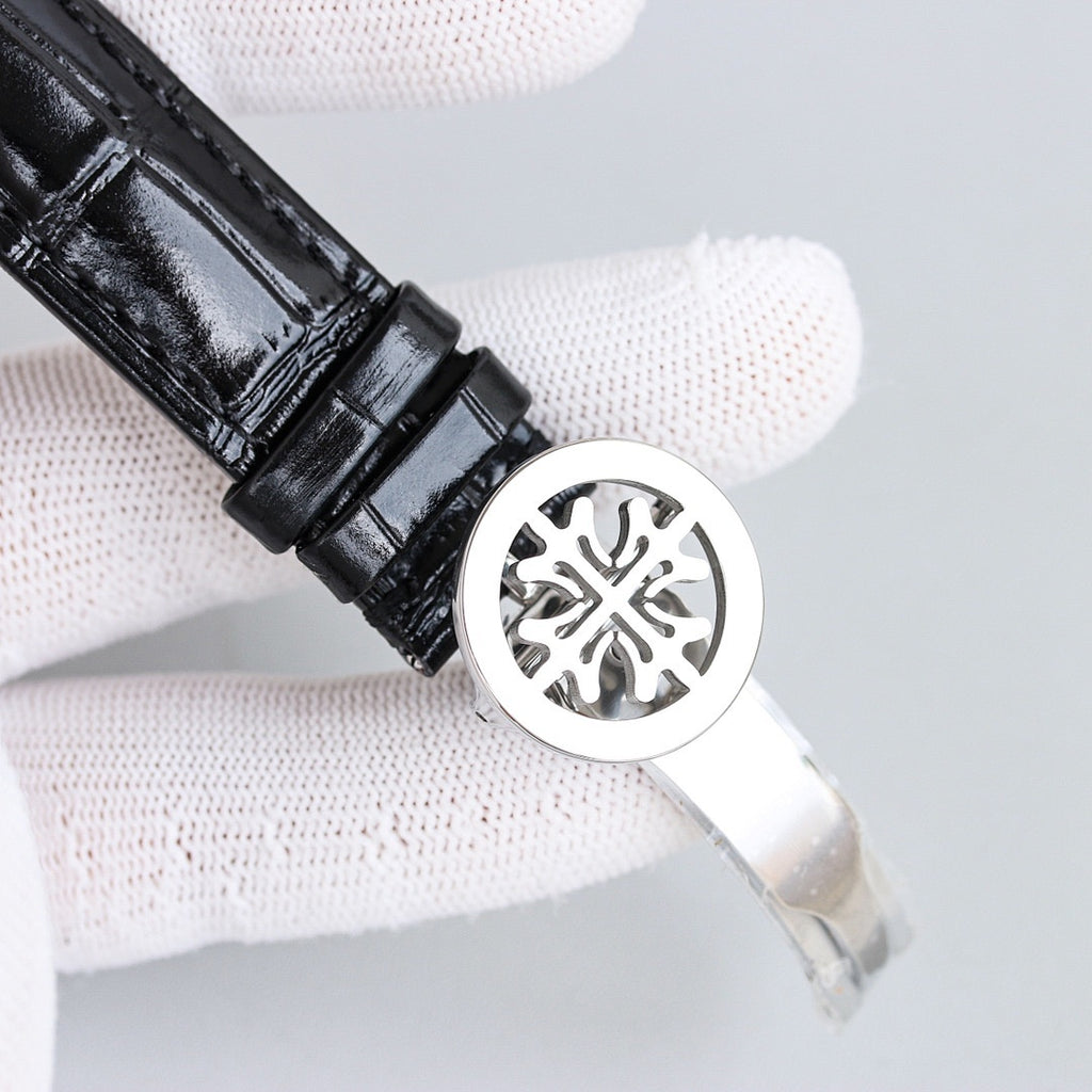 Patek Philippe wristwatch caseback with black leather strap and round metal back