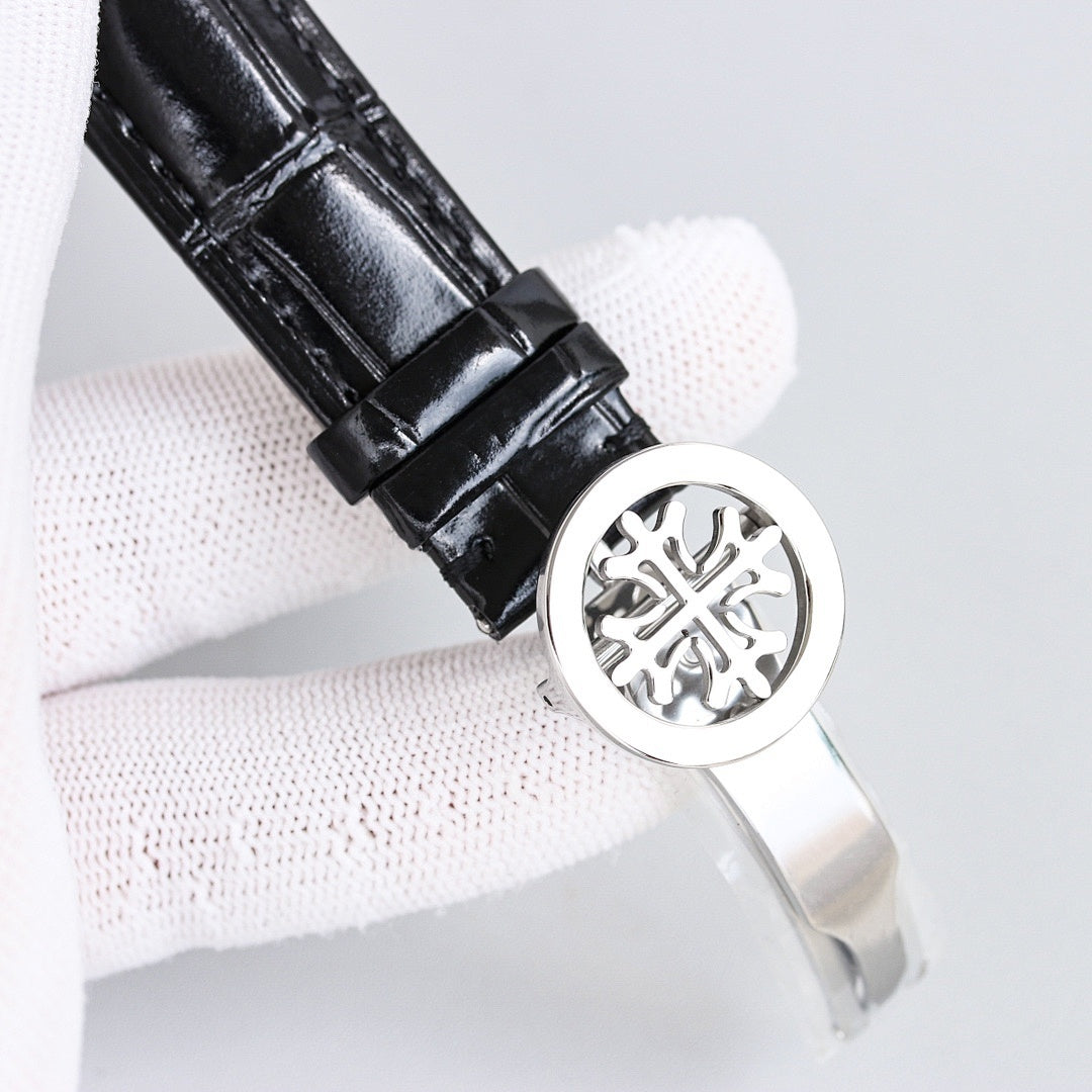 Patek Philippe watch black leather strap with round metal caseback badge, silver bezel