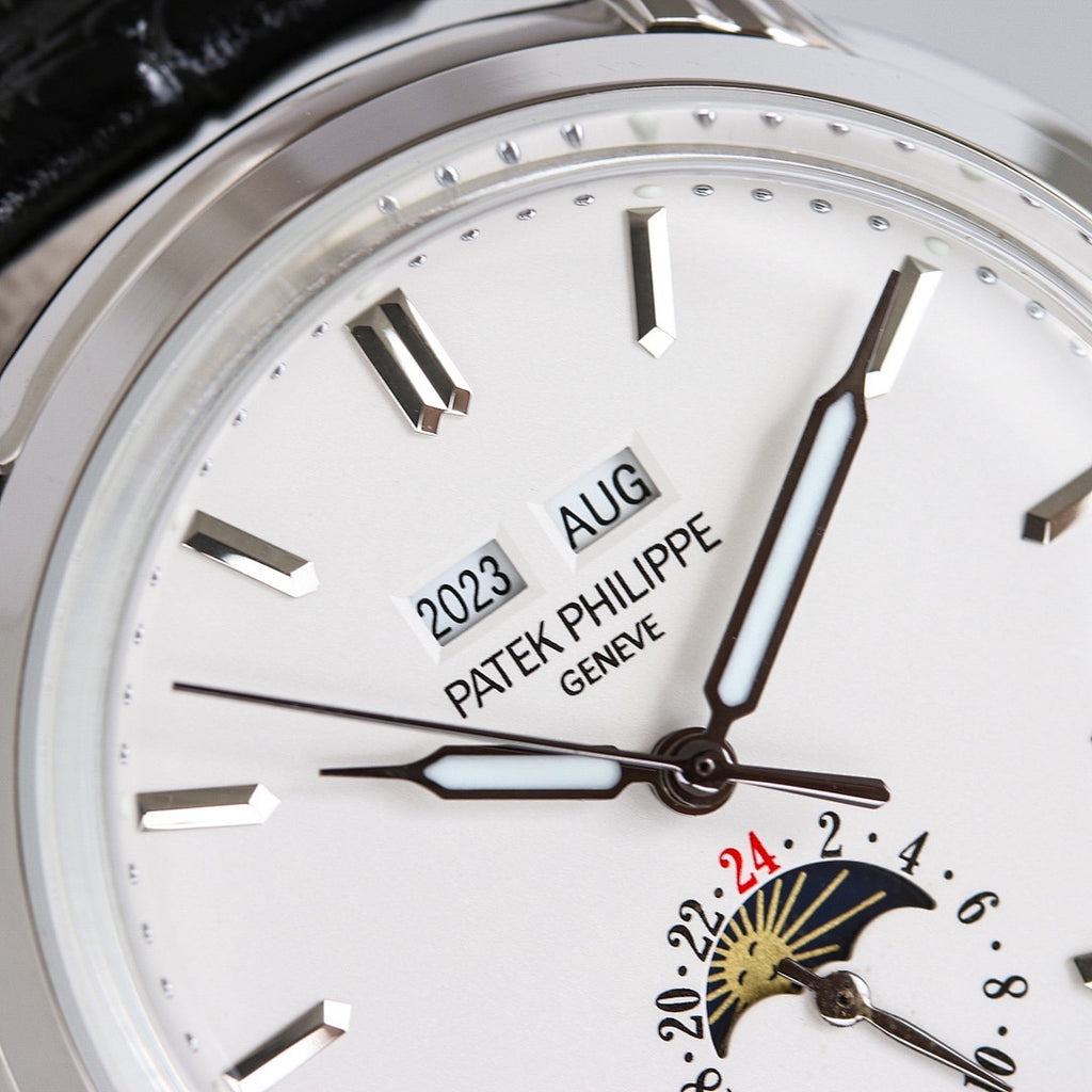 Patek Philippe watch dial close-up with gold-toned sunburst seconds subdial and baton markers