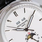 Patek Philippe watch dial close-up with gold-toned sunburst seconds subdial and baton markers