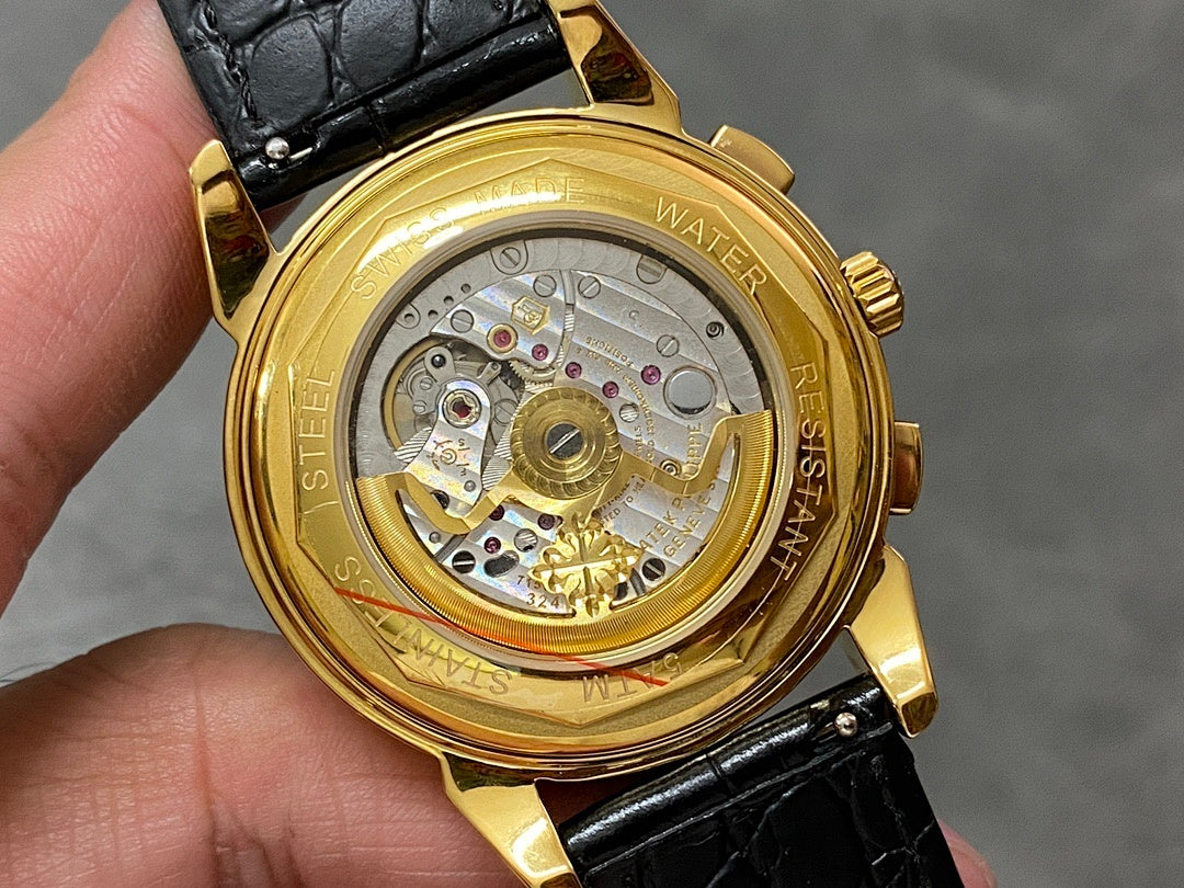Gold wristwatch caseback showing mechanical movement with jewel details; black leather strap.