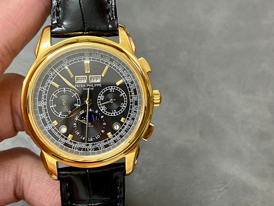 Gold wristwatch with black leather strap and Patek Philippe chronograph dial with subdials.