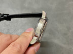 Wristwatch hinged clasp and case with black leather strap