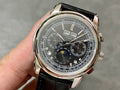 Wristwatch with black dial and silver case, black leather strap and round crown