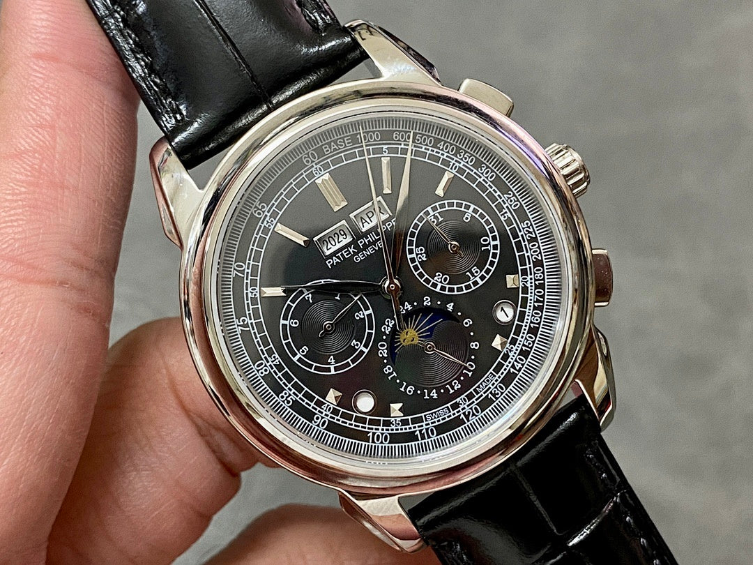 Wristwatch close-up with black dial, silver case, and black leather strap