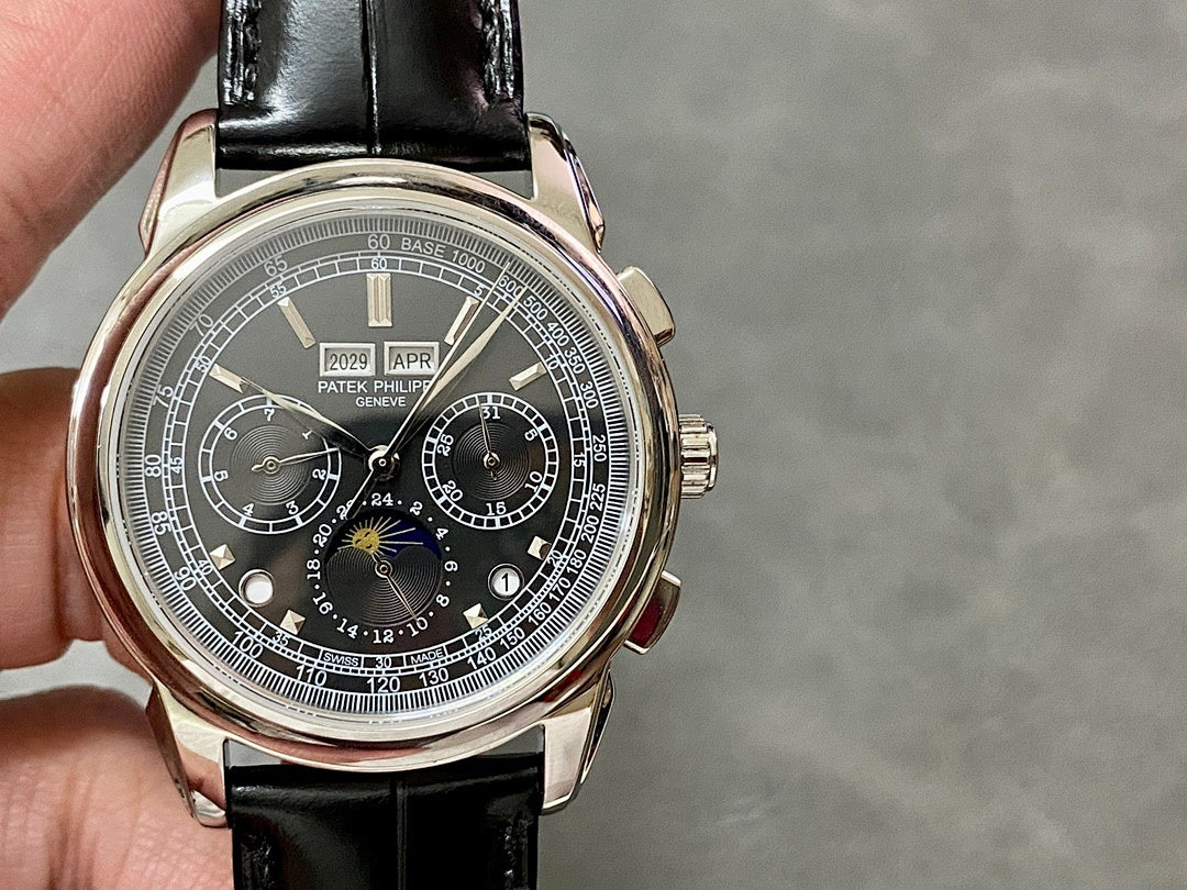 Wristwatch with black dial and silver case, black leather strap held in hand