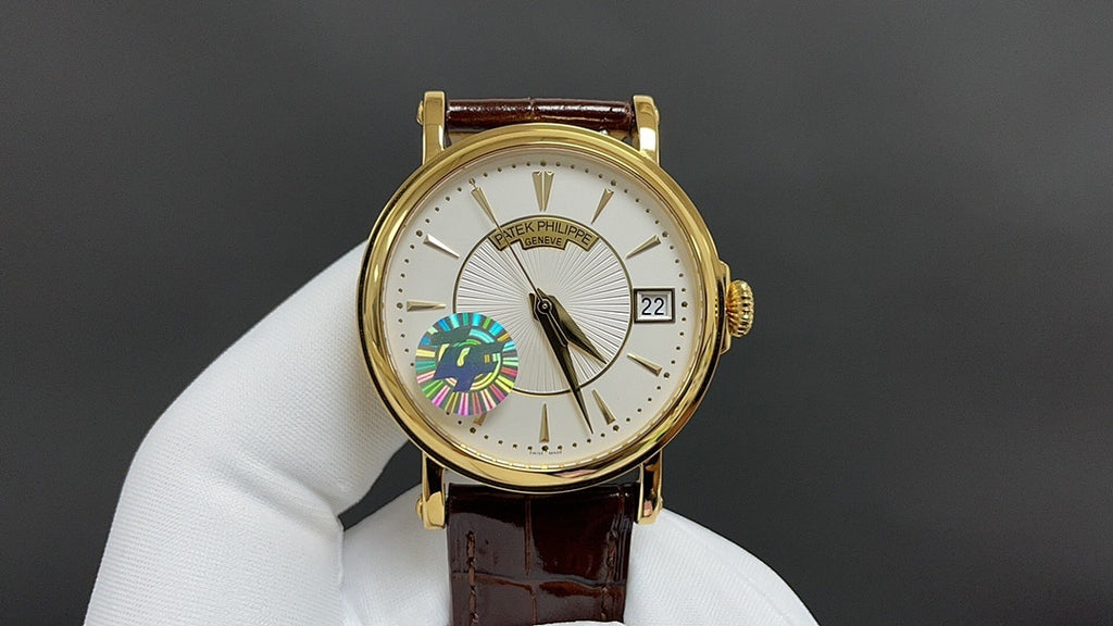 Patek Philippe wristwatch with gold case, white dial, brown leather strap