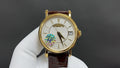 Patek Philippe wristwatch with gold case, white dial, brown leather strap