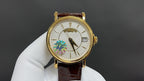 Patek Philippe wristwatch with gold case, white dial, brown leather strap