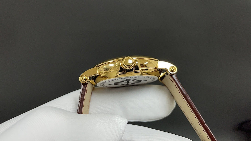 Patek Philippe wristwatch case back in gold with brown leather strap