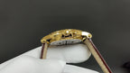 Patek Philippe wristwatch case back in gold with brown leather strap