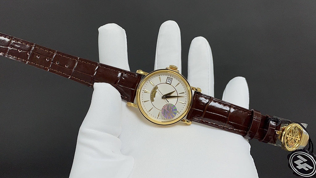 Patek Philippe wristwatch on brown leather strap with gold crown detail