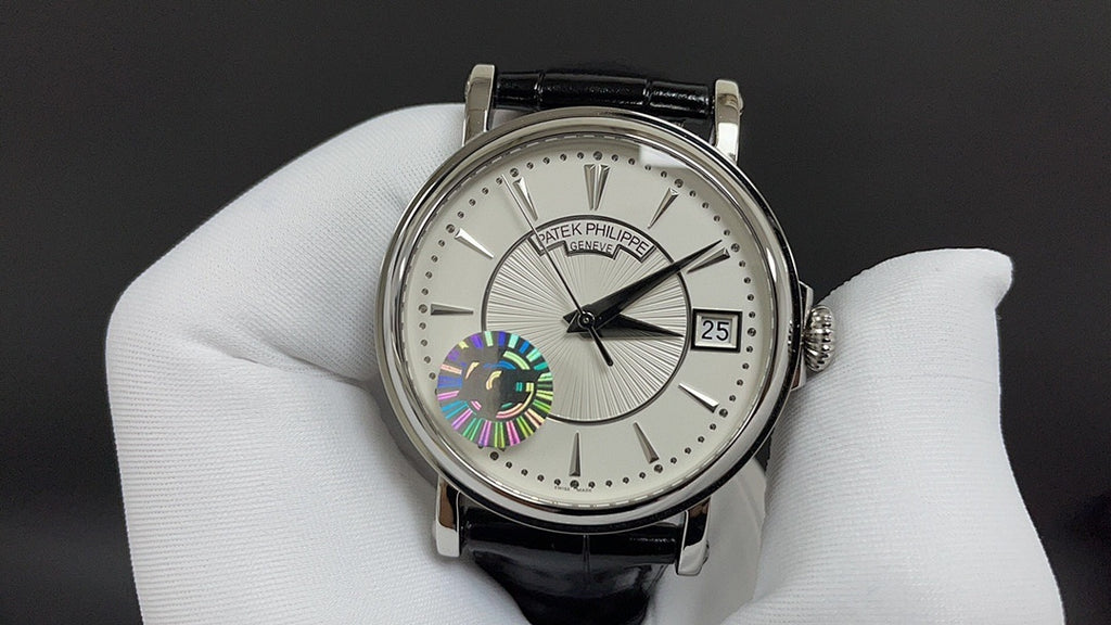 Patek Philippe wristwatch front view with white dial and black leather strap