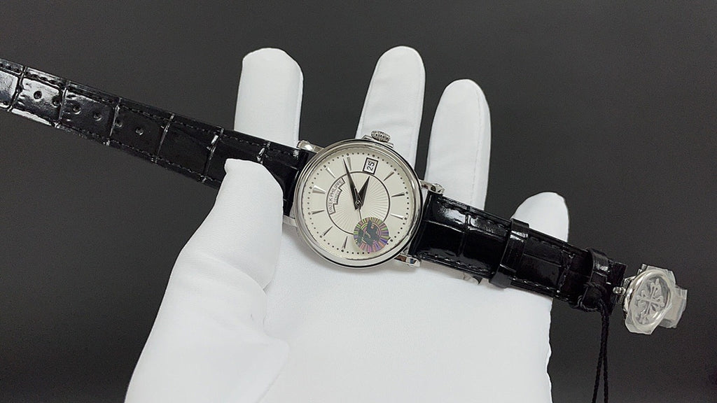 Patek Philippe wristwatch on black leather strap with buckle and clasp