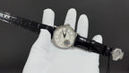 Patek Philippe wristwatch on black leather strap with buckle and clasp