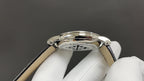 Patek Philippe watch case close-up with polished metal and visible crown