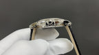 Patek Philippe watch crown and case detail with polished silver finish