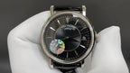 Patek Philippe wristwatch in silver with black dial and black leather strap