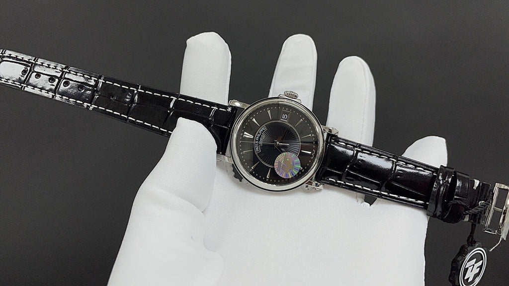 Patek Philippe wristwatch on white glove with black dial and crocodile-style strap