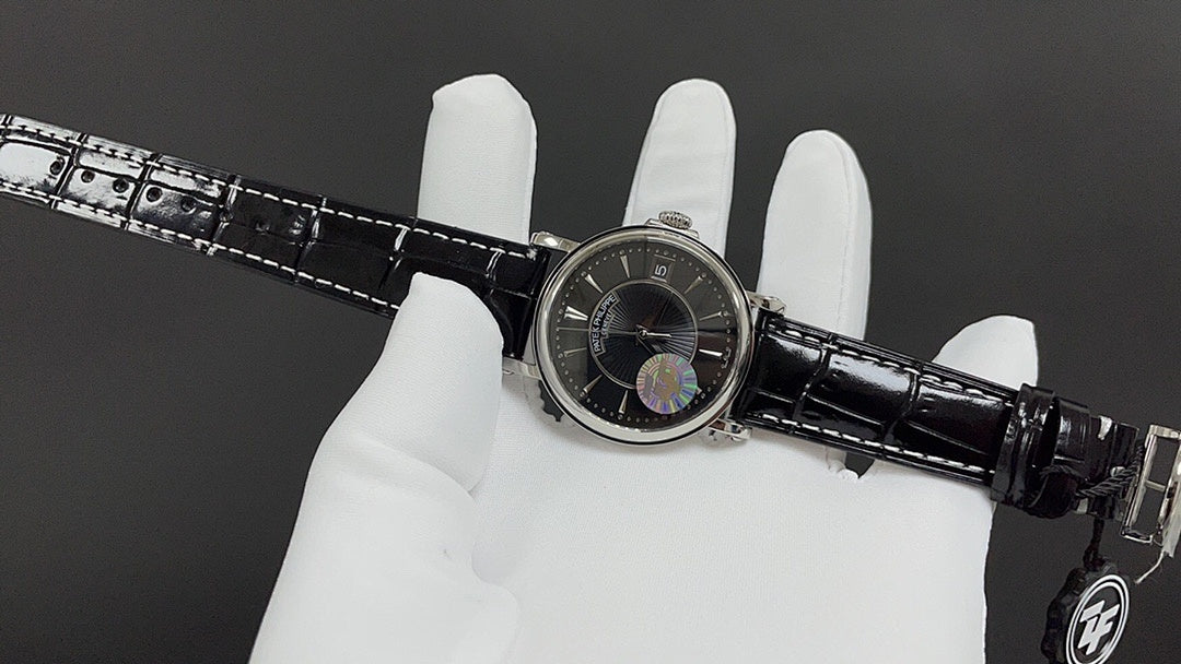 Patek Philippe wristwatch on white glove with black dial and crocodile-style strap