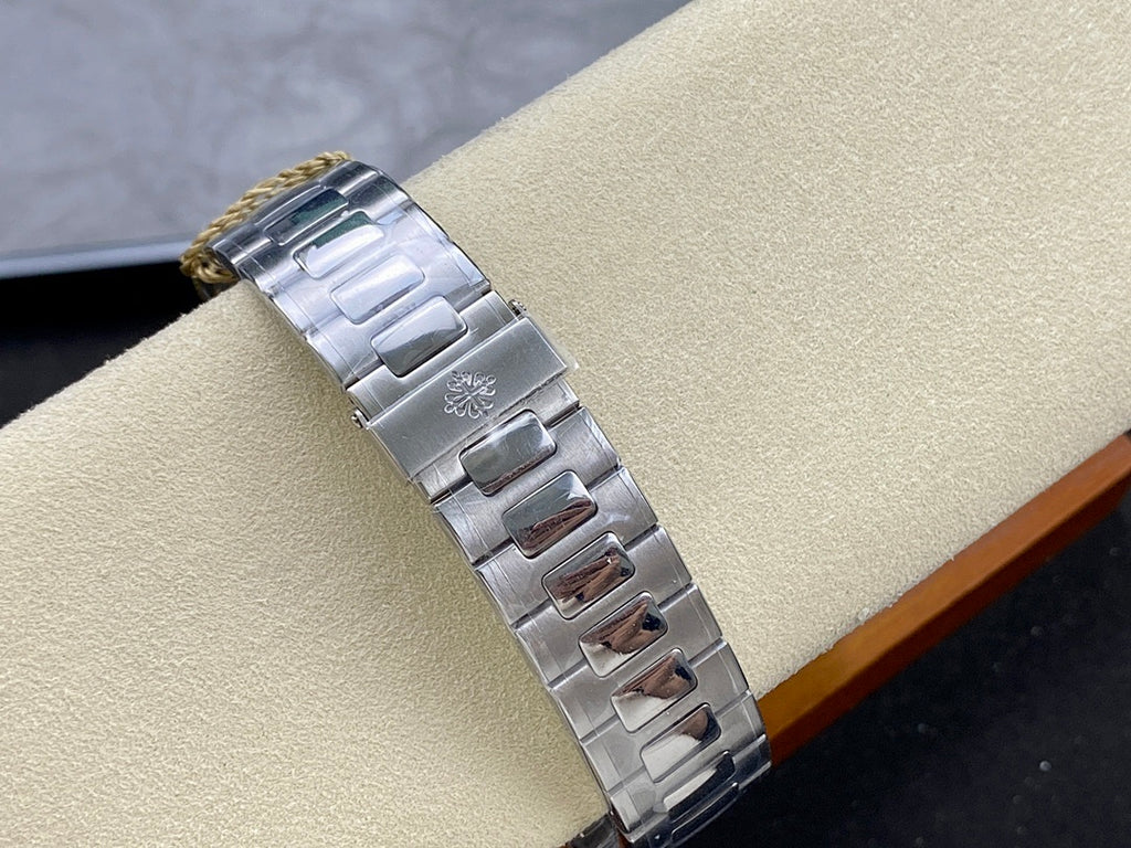 Stainless steel Patek Philippe watch bracelet with engraved clasp and link details.