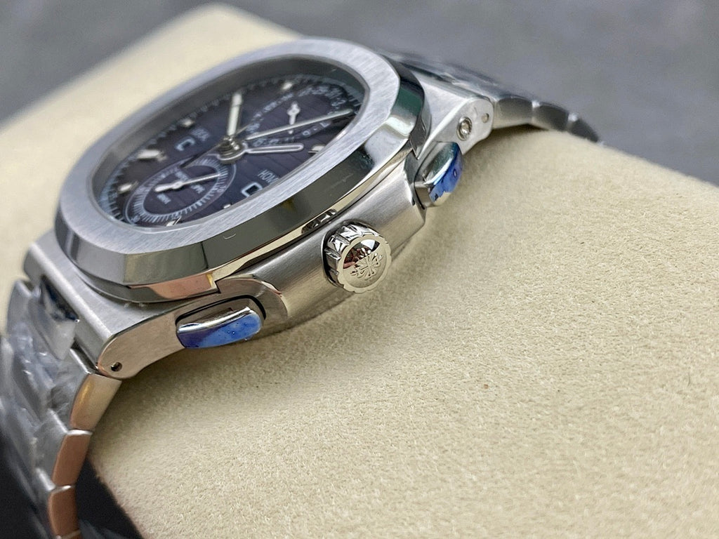 Stainless steel Patek Philippe wristwatch with crown and blue accents on the case.