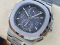 Stainless steel Patek Philippe wristwatch with black dial and dual-time subdials.
