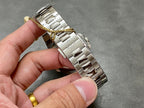 Patek Philippe metal bracelet with polished links and gold-toned accents near the clasp