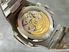 Patek Philippe watch back with gold-toned movement visible inside stainless case