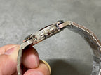 Patek Philippe watch side profile with crown, polished stainless case and bracelet links
