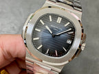 Patek Philippe stainless watch with blue sunburst dial, baton markers, date window
