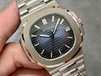 Patek Philippe watch close-up with blue dial, baton indexes, and date window at 12