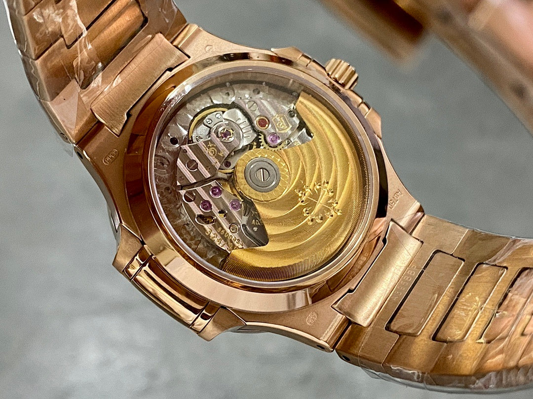 Gold-tone Patek Philippe wristwatch case back with visible mechanical movement