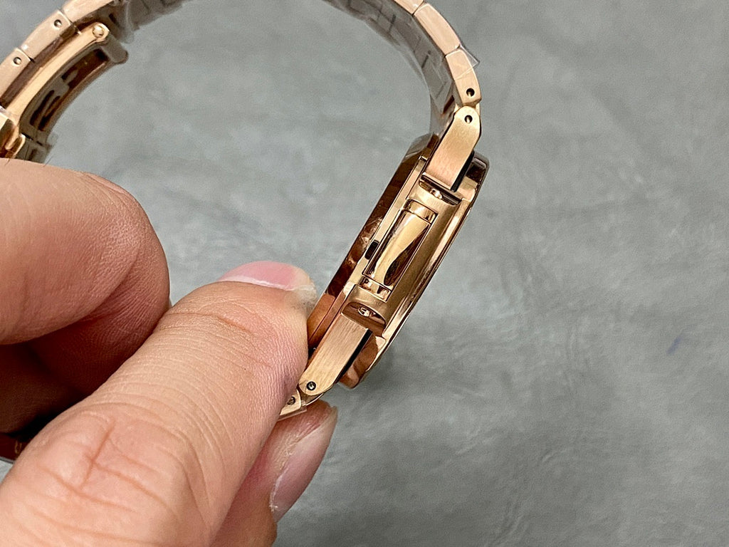 Gold-tone Patek Philippe wristwatch bracelet link detail, side view