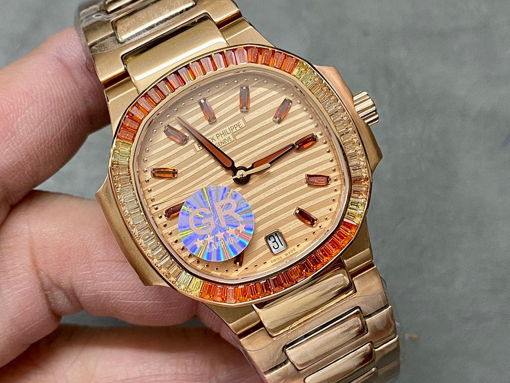 Gold-tone Patek Philippe wristwatch with champagne dial, red jeweled bezel, date window