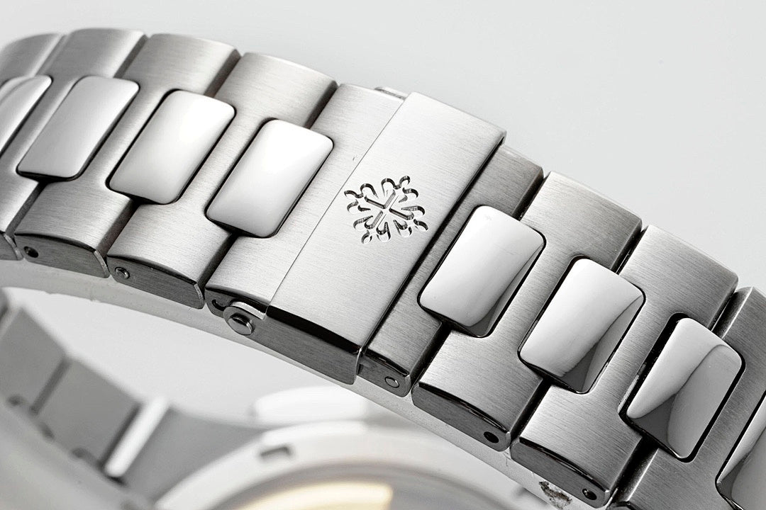 Stainless steel watch bracelet with engraved snowflake emblem and brushed metal links