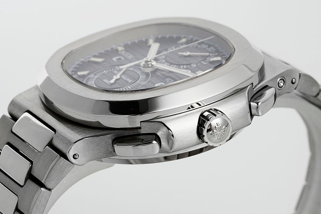 Stainless steel wristwatch with black dial from side angle, crown and pushers visible