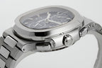 Stainless steel wristwatch with black dial from side angle, crown and pushers visible