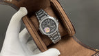 Patek Philippe watch on brown suede and leather strap with dark diamond dial