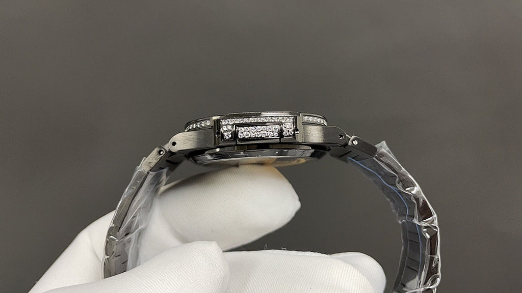 Patek Philippe watch case from side angle with diamond bezel and metal bracelet