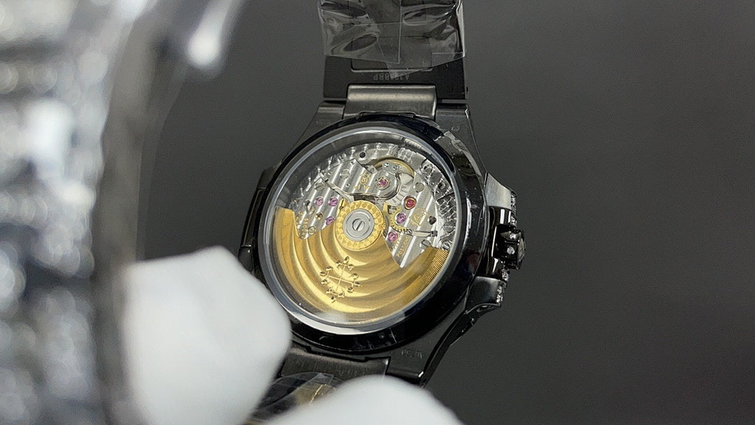 Patek Philippe watch open caseback showing gold-toned movement and black bezel