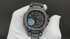 Patek Philippe watch with diamond bezel, dark dial, and silver link bracelet