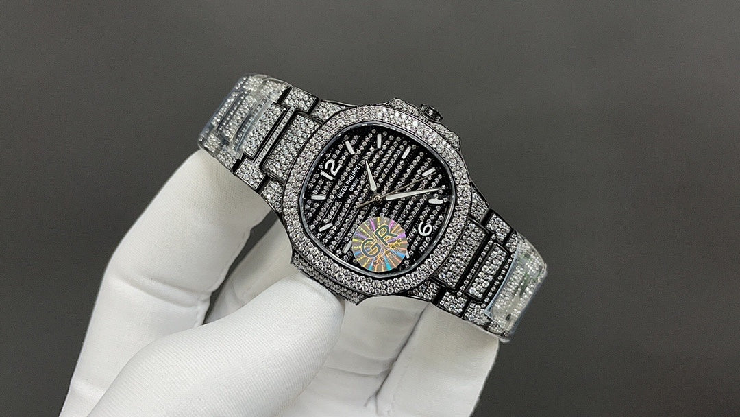 Patek Philippe watch with diamond bezel and dark dial on silver link bracelet