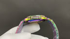 Jeweled wristwatch with iridescent rainbow bezel and links, viewed from above